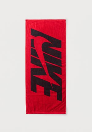 Prosop dreptunghiular roșu cu un logo mare stilizat Nike negru și swoosh centrat pe el.