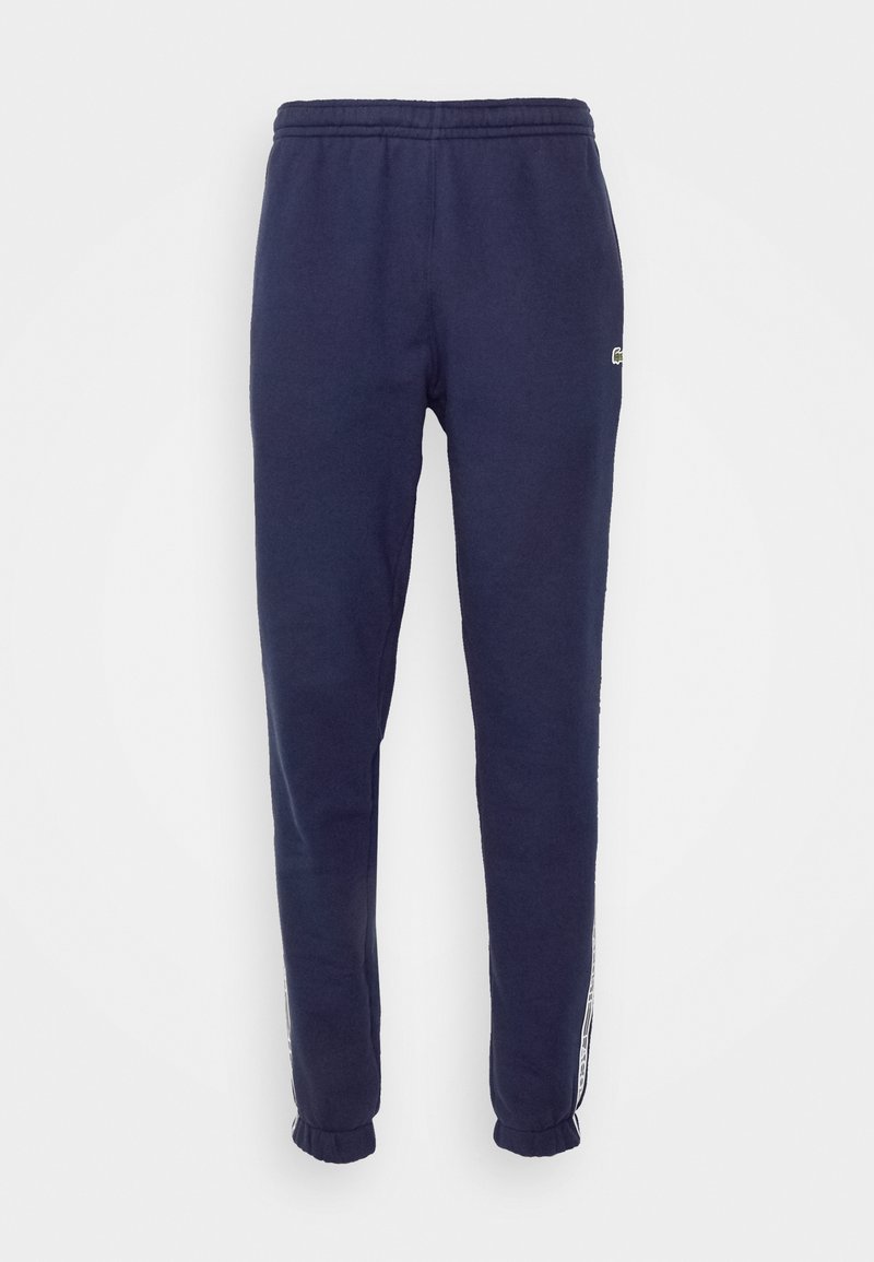 Pantalons de jogging navy en mélange de coton doux, avec une taille élastique, des poignets ajustés et un détail de rayure sur le côté.