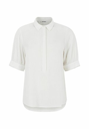 Baltā īsā piedurkņu krekls ar apkakli, ar slēptu pogu rindu un dekoratīvu apdari uz piedurknēm. Gluda auduma tekstūra.