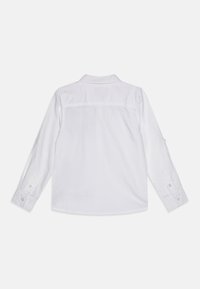 Witte langlopende blouse made van katoen met een button-down kraag, met een rugpasdetail en knoopmanchetten. Gladde textuur zonder patronen.