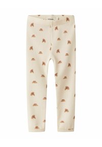 Crème ribgebreide leggings met een herhalend bruin dierenprintpatroon. Zachte textuur, elastische tailleband, strakke fit. Maat onbekend.