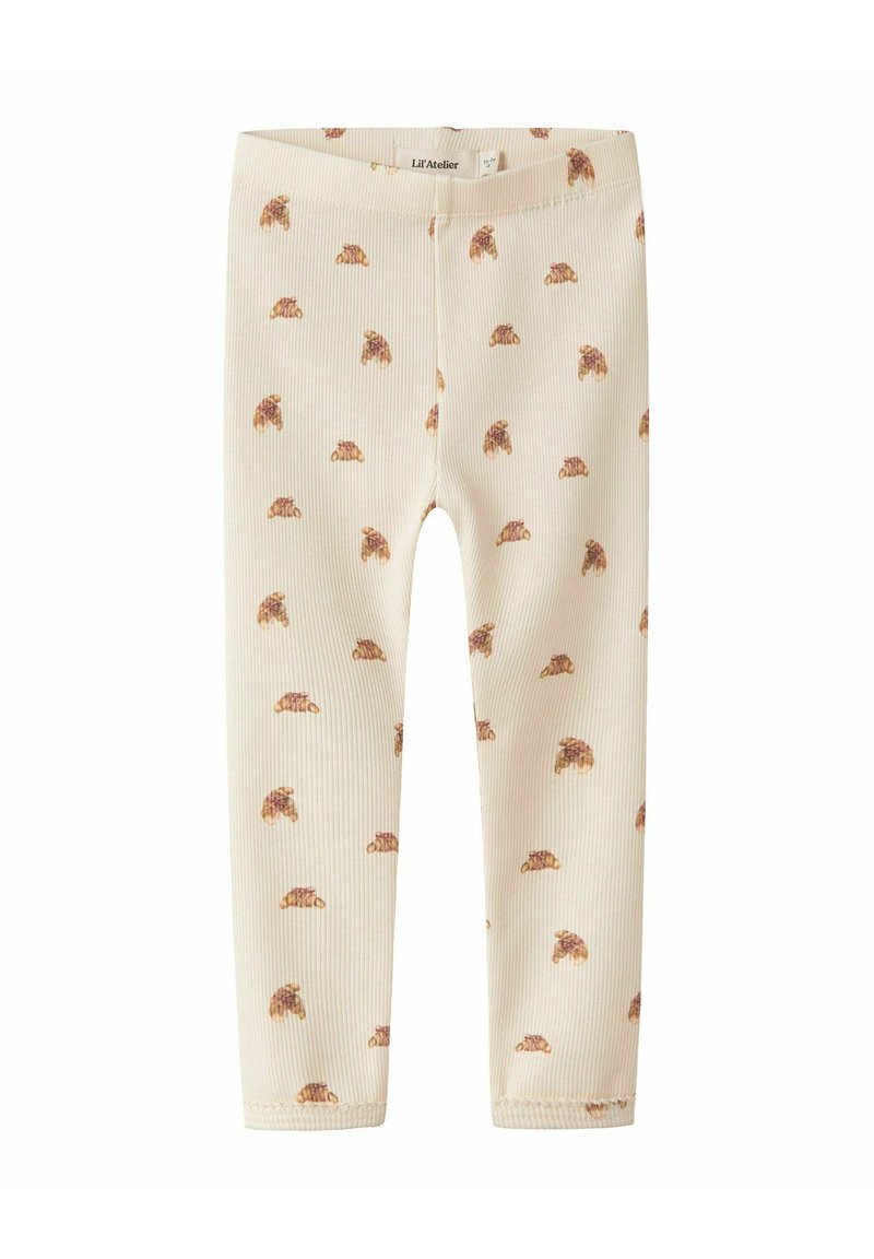 Crème ribgebreide leggings met een herhalend bruin dierenprintpatroon. Zachte textuur, elastische tailleband, strakke fit. Maat onbekend.