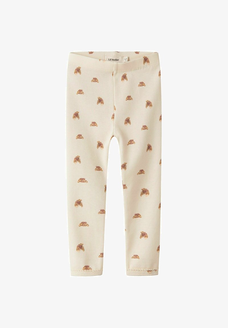 Crème ribgebreide leggings met een herhalend bruin dierenprintpatroon. Zachte textuur, elastische tailleband, strakke fit. Maat onbekend.