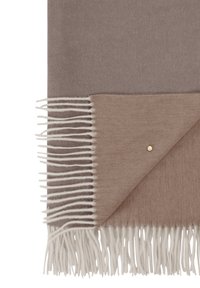 Couverture en laine marron avec un accent marron clair et des franges blanches. Un petit détail en clou doré est visible sur le bord.