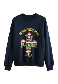 Marinblå sweatshirt med tryck föreställande skallar som bär tomteluva på ett grönt kors, med texten "WELCOME TO THE JINGLE" i gult.