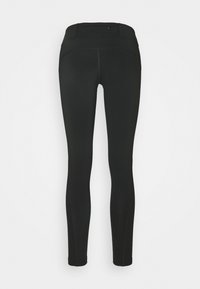 Leggings negros con una cintura alta, textura suave y costuras mínimas. El diseño permite libertad de movimiento y comodidad.