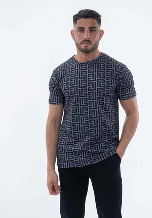 AUX MOTIFS RÉPÉTITIFS MONOGRAMME - T-shirt imprimé - noir