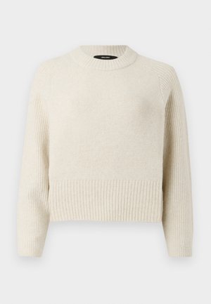 Pull tricoté beige clair avec un ourlet côtelé et un corps texturé. Il dispose d'un col rond et de manches longues avec une coupe décontractée.