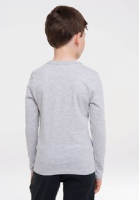 Long-sleeve gray shirt made of soft, jersey knit fabric; features a crew neckline and a relaxed fit, with no visible patterns or embellishments.