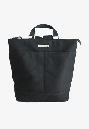 Black canvas tote bag with a square shape, featuring a top zipper closure, dual handles, and a front pocket with minimal hardware.