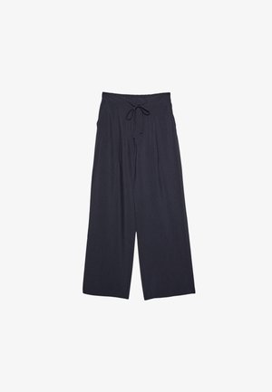 Wide-leg pants in dark navy, featuring a textured fabric, drawstring waistband, and loose silhouette for comfort.