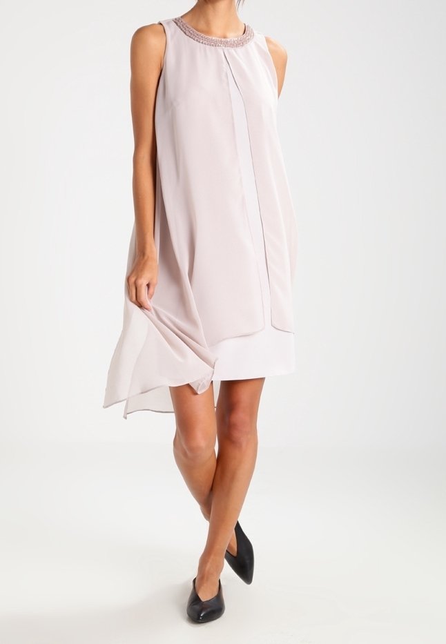 Robe sans manches en tissu rose clair au toucher lisse, avec un col rond orné et une coupe ample et fluide.