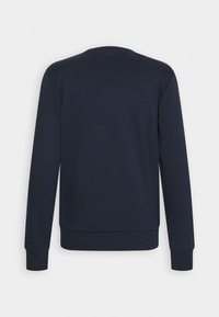 Sweat-shirt bleu marine à manches longues avec poignets et ourlet côtelés, vu de dos sur fond blanc uni.