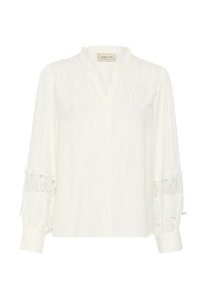 White shirt made of soft fabric, featuring lace detailing at shoulders and cuffs, button front, and a gently ruffled collar.