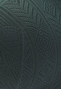 Dark green knitted fabric featuring geometric patterns and textures, with open weaves and smooth sections, highlighting intricate design details.