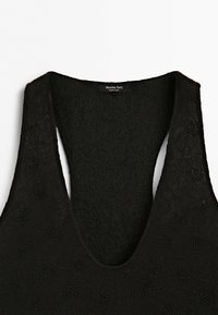 Black textured fabric with delicate beaded floral patterns and a wide scoop neckline, labeled Massimo Dutti, made in India.