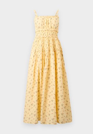 Vestido maxi amarillo sin mangas con estampado floral, corpiño fruncido, cintura con volantes y tirantes finos.