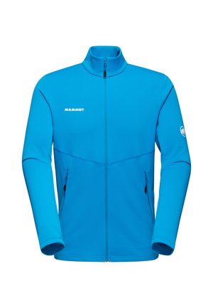 Giacca in pile blu con colletto alto, zip frontale completa, due tasche laterali e logo Mammut sul petto e sulla manica. Texture liscia.