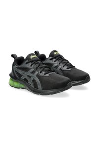 Scarpe da ginnastica nere con accenti grigi, tomaia in tessuto testurizzato e imbottitura verde nella suola. Presentano lacci tradizionali e un tallone ad anello.