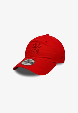 Red baseball cap with an embroidered NY logo, made of fabric with a smooth texture. Features a structured, curved brim and an adjustable strap.