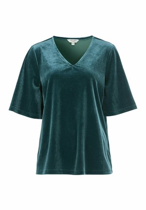 Tegenblauw fluwelen top met een V-hals, korte mouwen en een losse pasvorm. De stof heeft een gladde textuur en een subtiele glans. Zorglabel zichtbaar.