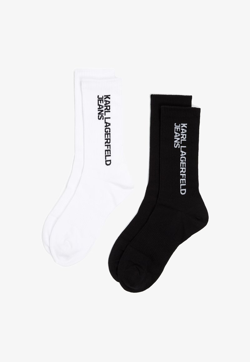 Dos pares de calcetines de algodón, uno blanco y otro negro, con el texto "KARL LAGERFELD JEANS" en colores contrastantes. Textura de canalé.