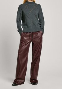 Gray knitted sweater with a ribbed turtleneck and diamond patterns, paired with burgundy faux leather wide-leg pants. Black shoes.