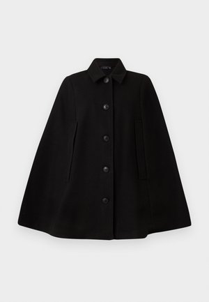 Cappotto a mantello in lana nera con colletto, chiusura anteriore con bottoni, tasche laterali e una silhouette strutturata. Tessuto liscio, senza motivi o decorazioni.
