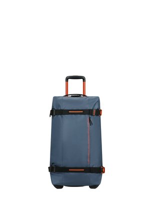 Rolling duffel bag in dark blue fabric, featuring orange accents. It has a retractable handle, side handles, and a zippered front pocket.
