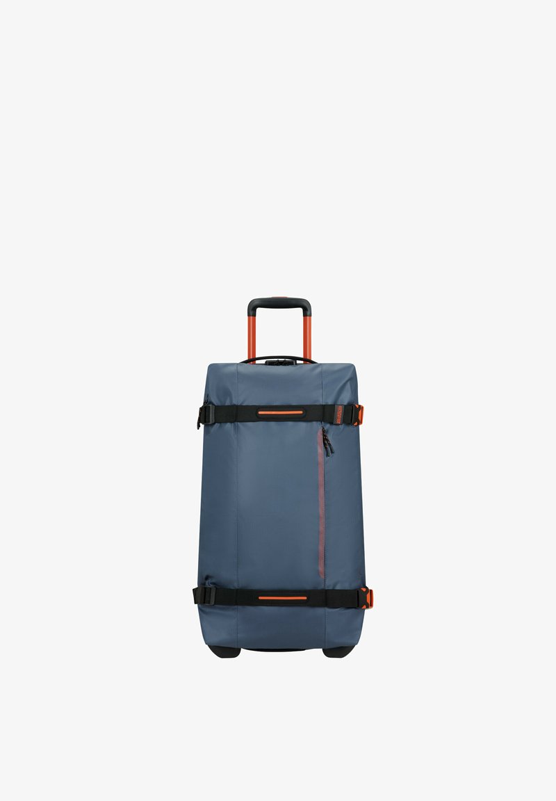 Rolling duffel bag in dark blue fabric, featuring orange accents. It has a retractable handle, side handles, and a zippered front pocket.