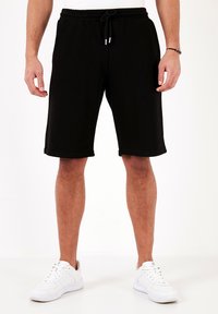 REGULAR FIT - Träningsbyxor - black