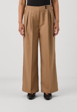 Wide-leg trousers in light brown fabric with front pleats, featuring a high waist and two black button closures at the waistband.