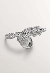 Brazalete de plata en forma de serpiente con escamas texturizadas y una cabeza detallada, diseñado en forma de espiral. Acabado de metal suave y pulido.