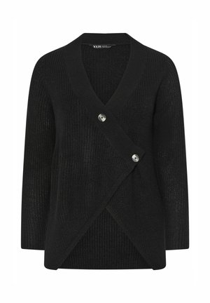 Musta neulottu neuletakki, jossa epäsymmetrinen etukappale kahdella isollla napilla kiinnitettynä, pitkät hihat ja V-kaula-aukko.