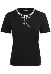 Svart t-shirt med kort ärm, tillverkad av bomull, med en design av strassrosett vid halsringningen och en jämn textur.