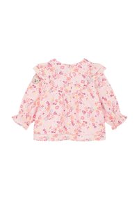 Blouse rose à motifs floraux avec des manches volantées, taille froncée et un patch d' ours sur la manche gauche. Tissu doux et léger.