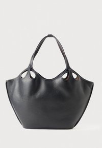 Black leather tote bag with a textured surface, featuring cut-out handles and a wide, curved silhouette. No hardware or patterns.