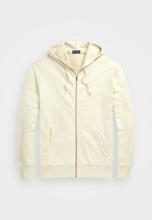 Sweat à capuche beige zippé avec poches à l'avant, capuche à cordon de serrage, poignets côtelés et petit logo Polo Ralph Lauren sur la poitrine.