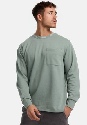 Sudadera de manga larga en algodón verde claro, con cuello redondo, detalle de logo, bolsillo frontal y puños acanalados.