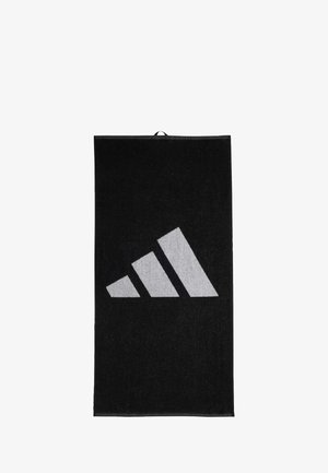 Black towel with a textured surface, featuring a large grey Adidas logo in the shape of three diagonal stripes. Rectangular design, hanging loop included.
