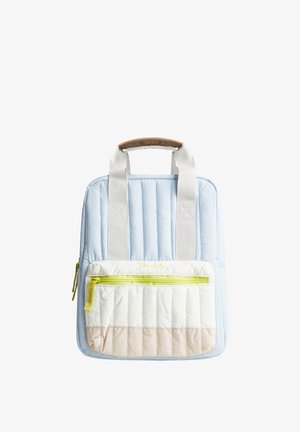 Light blue quilted backpack with beige front pocket, yellow zipper, and white handles with brown leather grip on a white background.