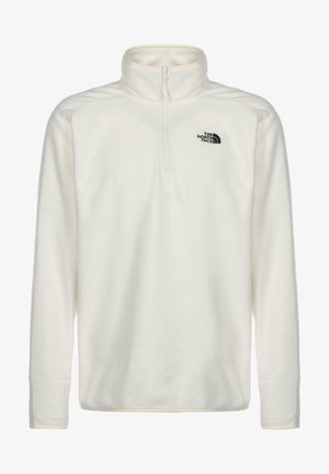 Biały polar z długim rękawem, z krótkim zamkiem i wysokim kołnierzem, z czarnym logo "The North Face" na lewej piersi.