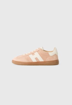 Light pink suede sneaker with a cream accent and logo, flat rubber sole, and white laces. Features a cushioned heel for comfort.
