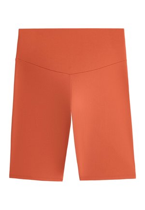 Rust-colored high-waist biker shorts with a smooth fabric and subtle V-shaped seam detail at the waistband.