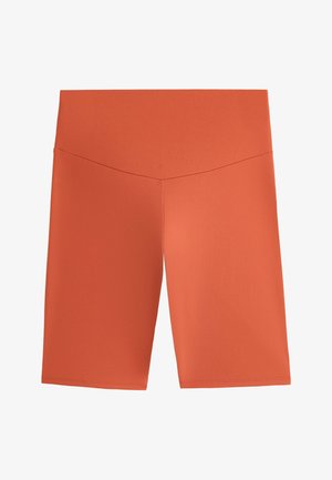 Ruosteväriset korkeavyötäröiset pyöräilyshortsit, joissa on sileä kangas ja hillitty V-muotoinen sauman yksityiskohta vyötäröllä.