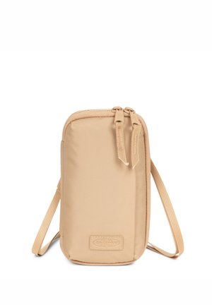 Valkoinen nailonipussi, jossa on suorakulmainen muoto, varustettu vetoketjulla ja kahdella vetotassulla. Sisältää irrotettavan hihnan ja logopatteen.