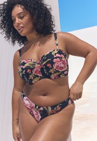 Lillelise printi ja tumeda taustaga bikini, kus on suured roosad roosid, struktureeritud rinnahoidja reguleeritavate rihmadega ning madala vöökohaga püksikud.