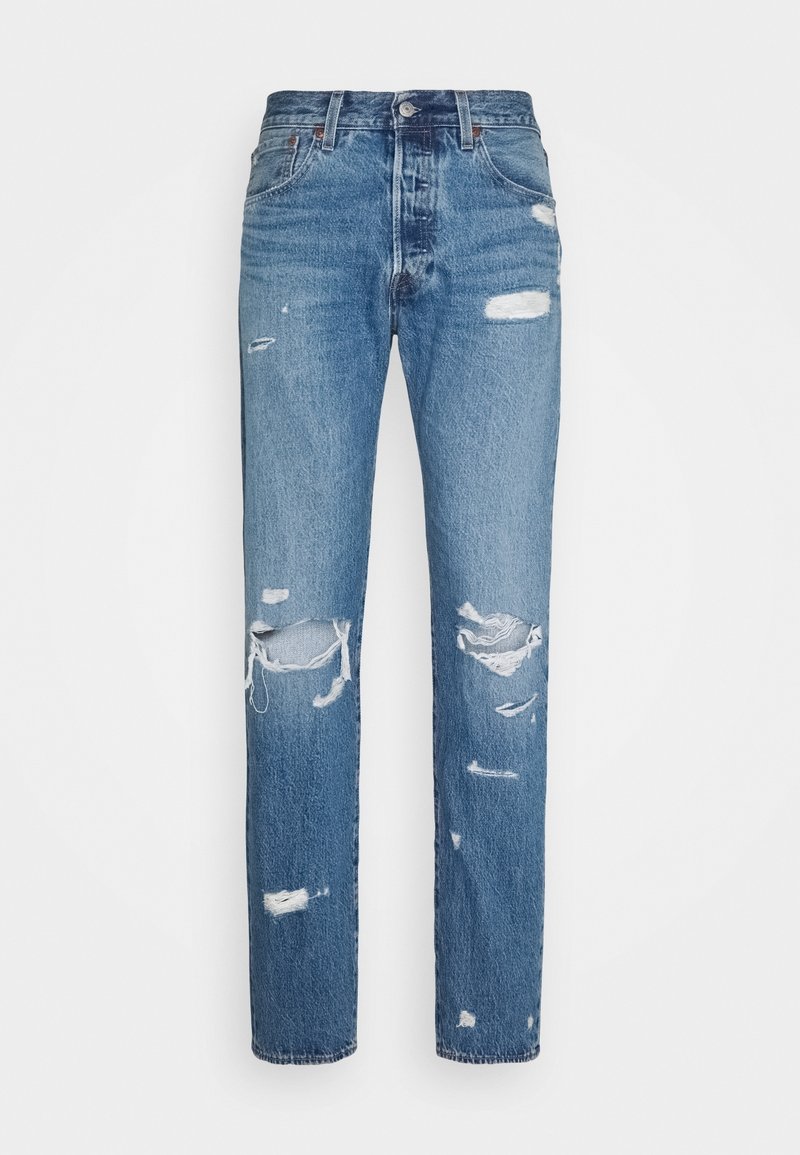 Jean en denim bleu avec une taille haute et plusieurs zones usées et déchirées à l'avant des jambes.
