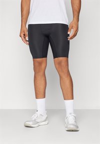 Mustad mustad sportlikud šortsid, mis on valmistatud venivast kangast, sobiva disainiga, keskmise reie pikkusega, kontrastsete õmblustega ja elastse vöökohtadega.