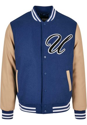Marineblå varsity-jakke med beige ærmer, med en fremtrædende broderet "U"-logo og striped ribbestrikkede manchetter og talje.